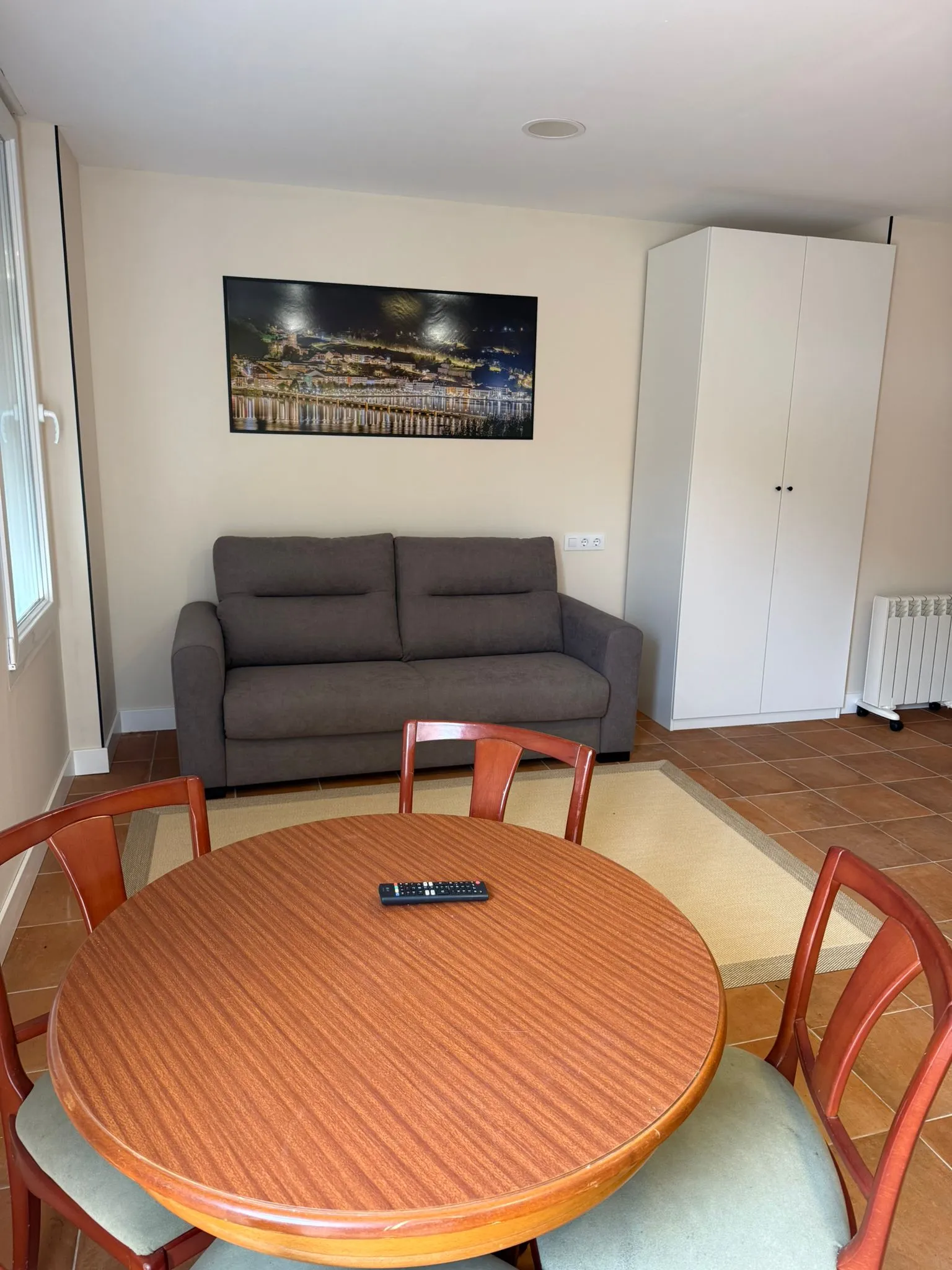 Studio living area with sofa and wardrobe